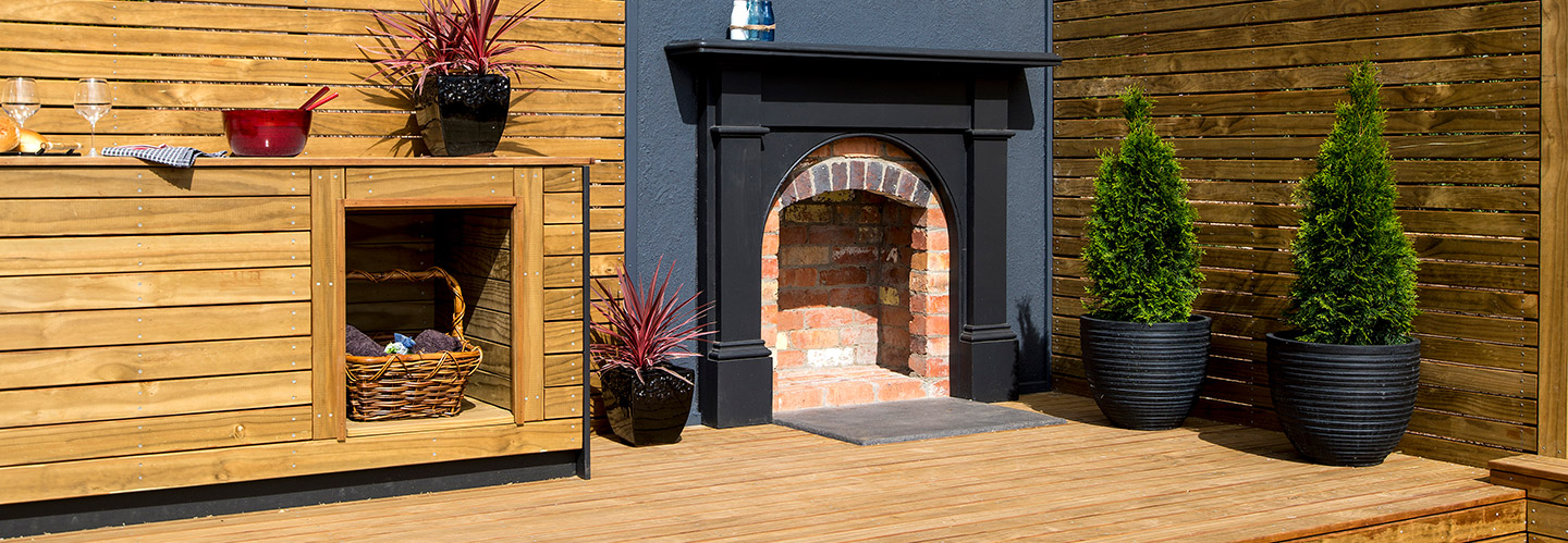 outdoor living area with timber deck and fireplace